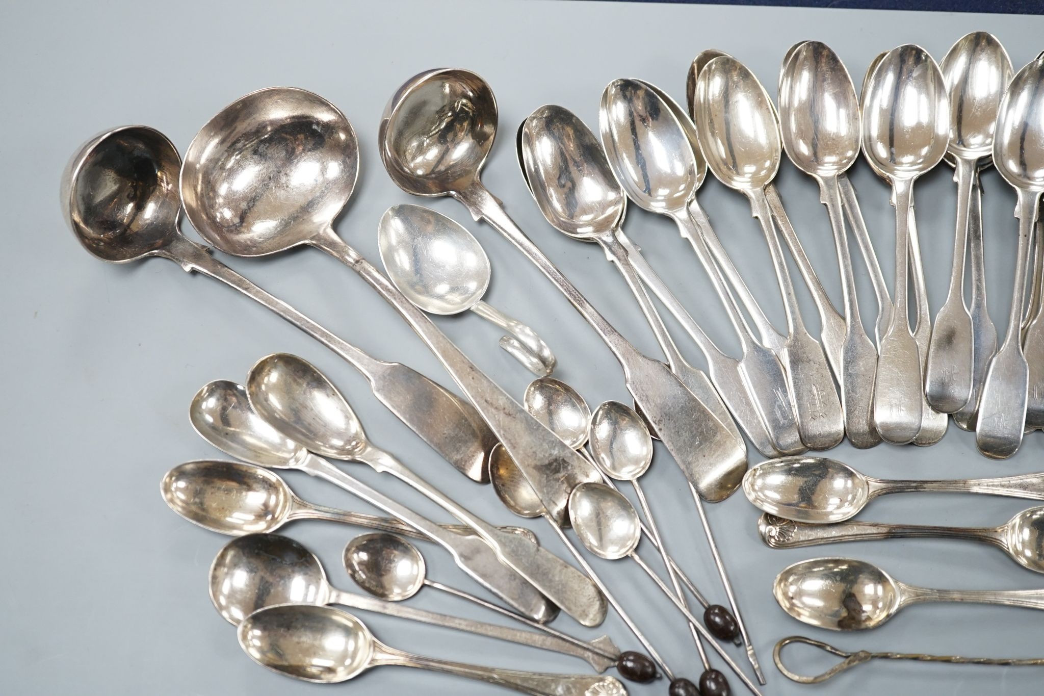 A set of twelve Victorian silver fiddle pattern teaspoons, London, 1870, a pair of Victorian sauce lades and a quantity of assorted sundry silver flatware